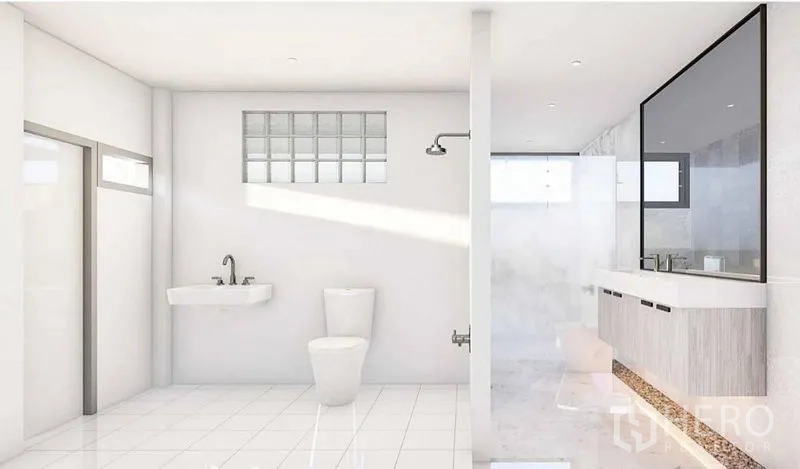 Detached House for rent in Lat Phrao, Bangkok - Bright bathroom with white tiles, toilet, wall sink, walk-in shower and long vanity with mirror.