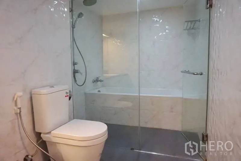 คอนโด ให้เช่าในWatthana, Bangkok - ห้องน้ำสมัยใหม่ กั้นกระจกพร้อมฝักบัวและอ่างอาบน้ำ ผนังกระเบื้องสีขาว