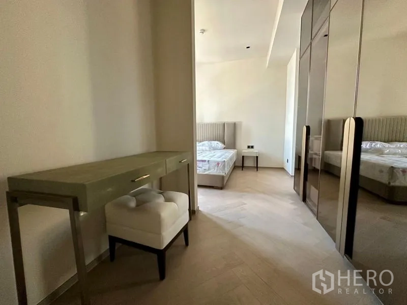 Condominium for rent - Dressing area with console desk, cushioned stool and mirrored wardrobes leading to bedroom.