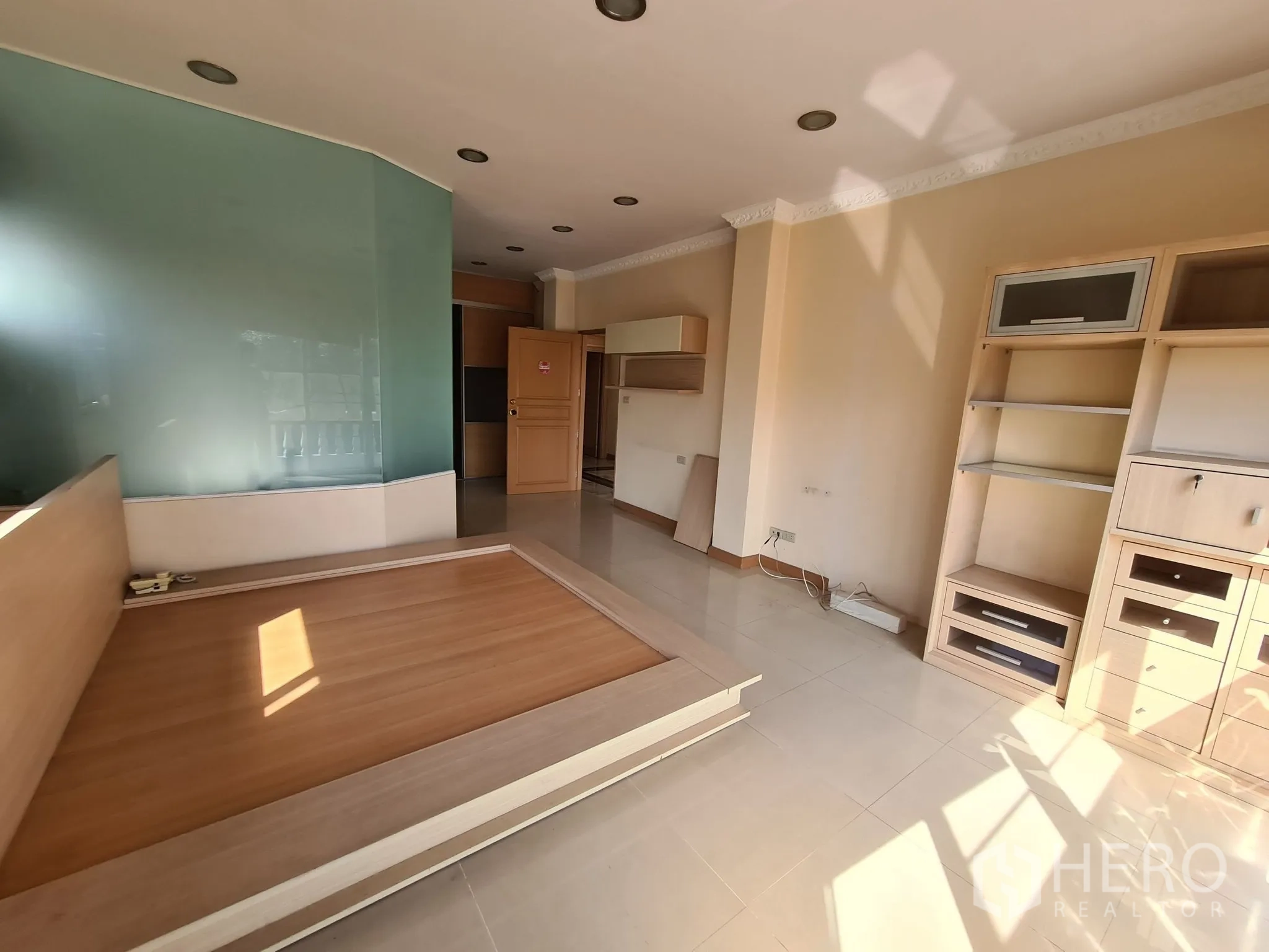 Detached House for sale in Chatuchak, Bangkok - Sunlit bedroom with built-ins and frosted glass feature wall.