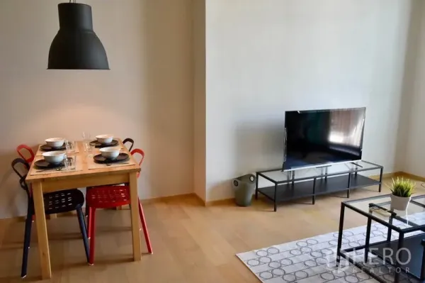 Condominium for rent in Phaya Thai, Bangkok - Dining corner with black pendant light and TV console in a contemporary Ari condominium.