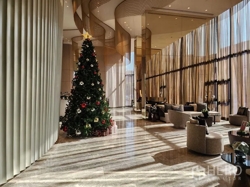 Condominium for rent - Grand lobby with high ceilings, soft seating and a decorated Christmas tree.