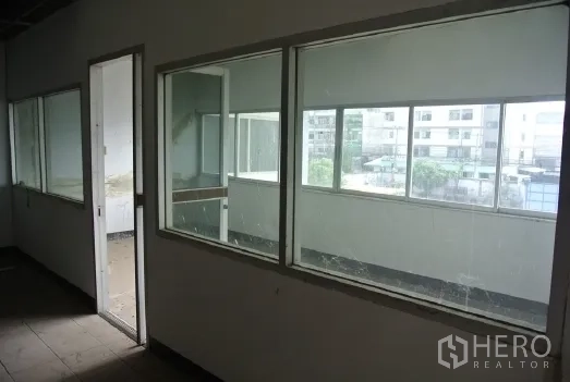 工厂 出售在Bang Phli, Samut Prakan - 走廊设大玻璃窗与门，可眺望院内。