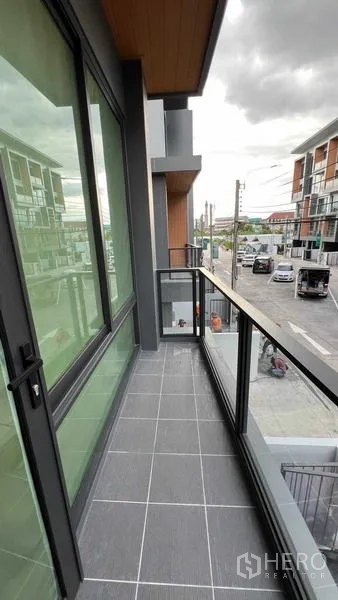 Home Office for rent - Slim balcony with glass railing overlooking the street and neighboring townhouses.