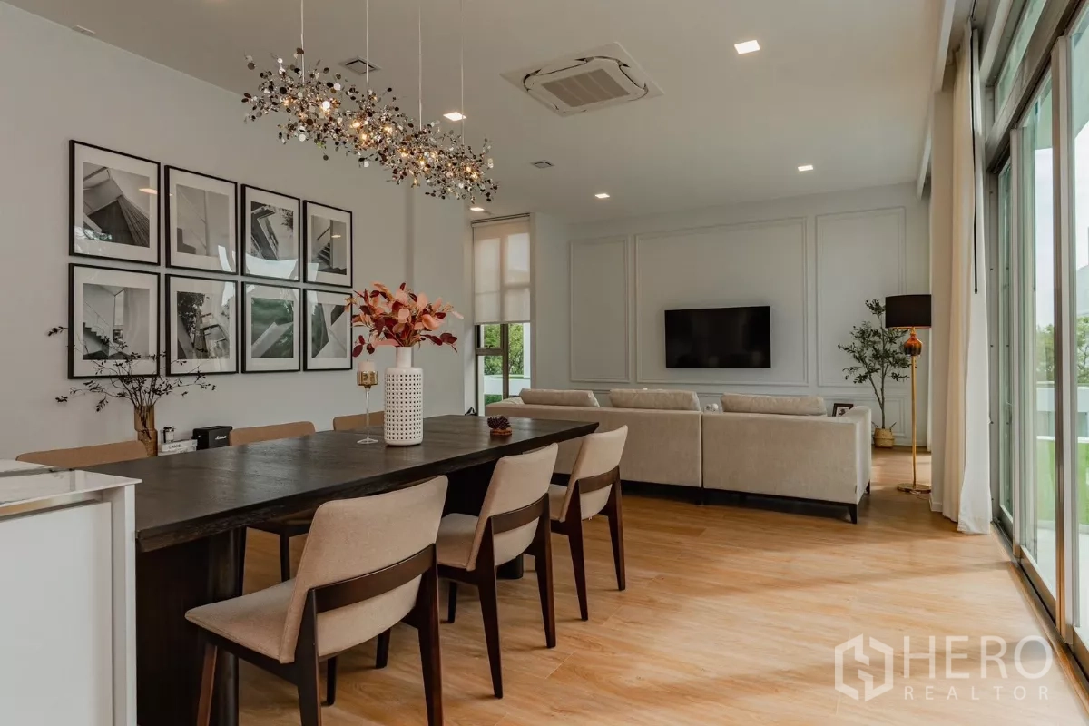 Detached House for rent in Saphan Sung, Bangkok - Open-plan dining and living area with pendant lights and sliding glass doors.