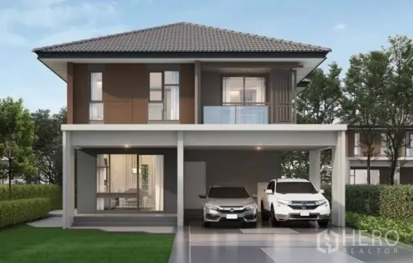 Detached House for rent or sale in Lam Luk Ka, Pathum Thani - Front elevation of a contemporary two-storey detached home with balcony and two-car driveway.