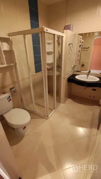 Detached House for rent in Bang Phli, Samut Prakan - Bathroom with glass shower enclosure, toilet and vanity.