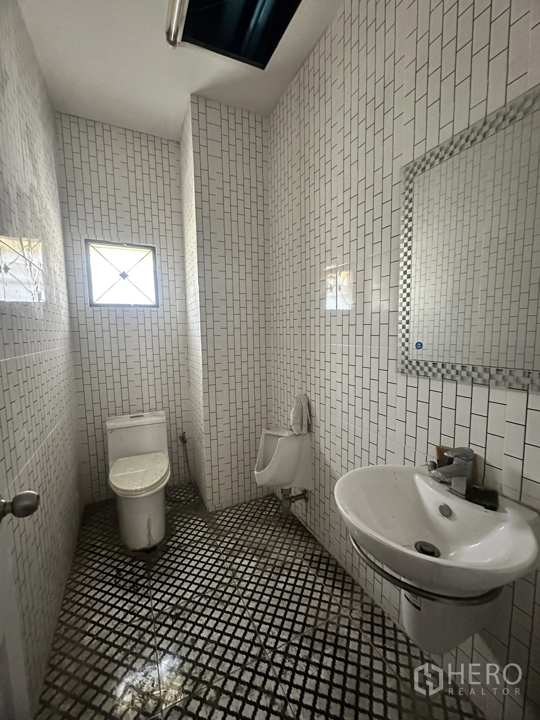 Factory for sale in Bang Bua Thong, Nonthaburi - Restroom with white wall tiles, sink, toilet, and urinal.