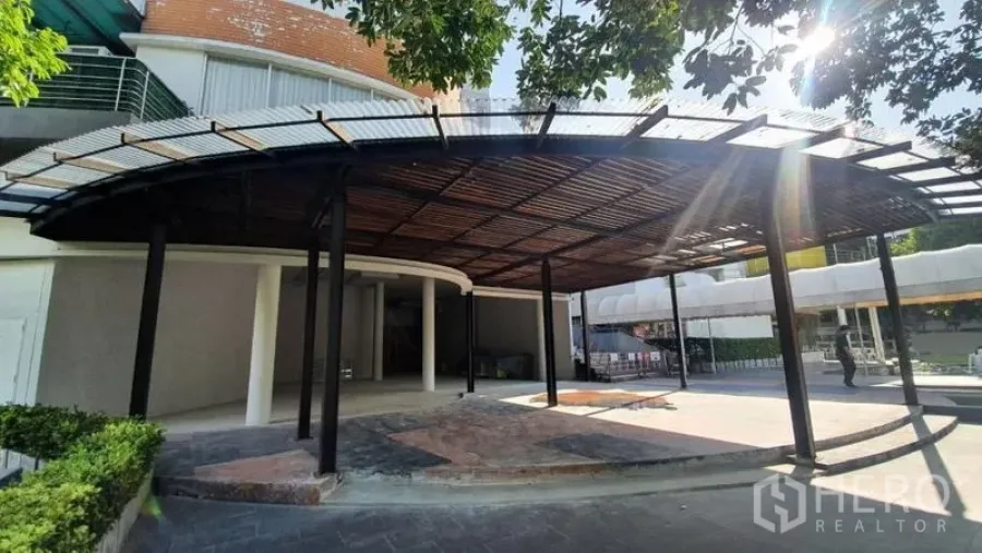 Retail Space for rent in Khlong Toei, Bangkok - Ground-floor retail unit exterior with large steel-and-wood canopy and landscaped forecourt.