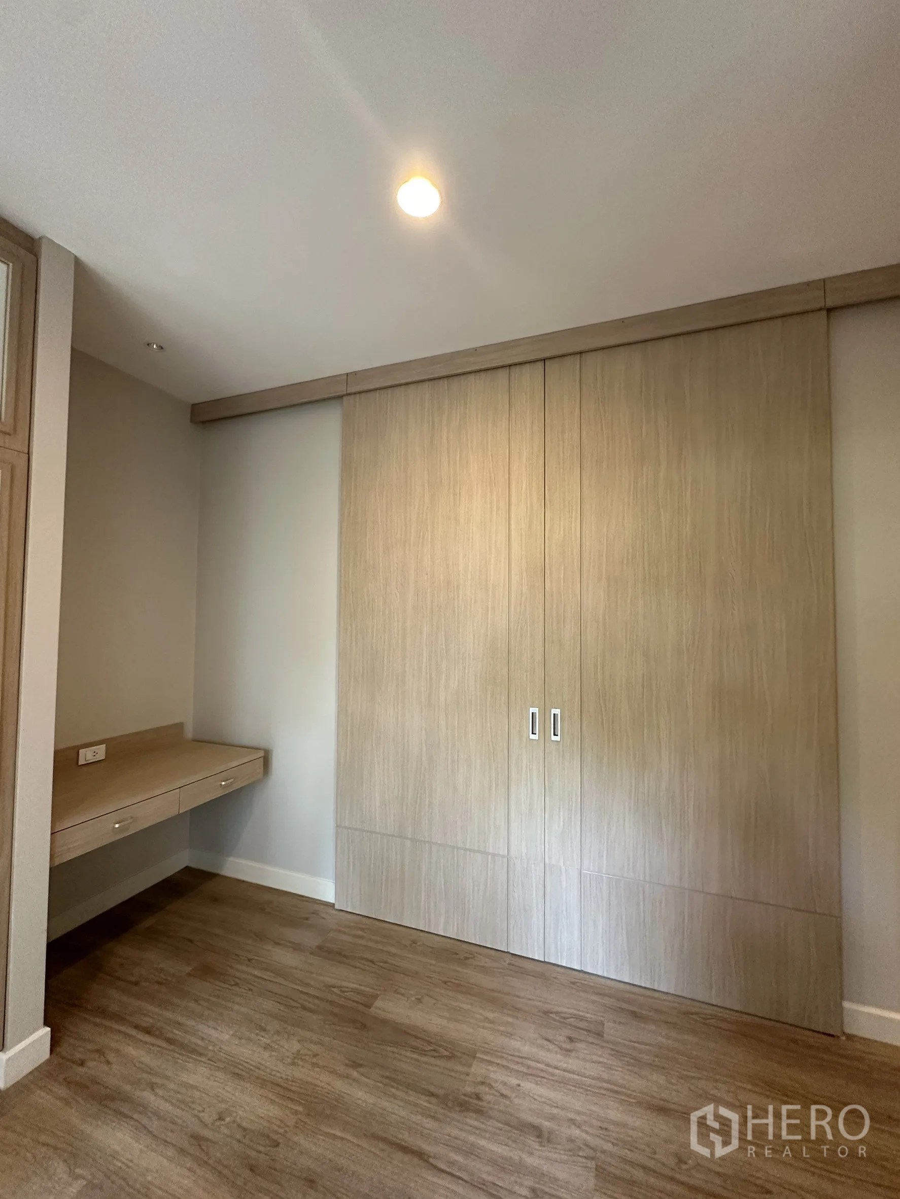 Detached House for sale in Lam Luk Ka, Pathum Thani - Cozy bedroom or study with built-in desk and sliding-door wardrobe.