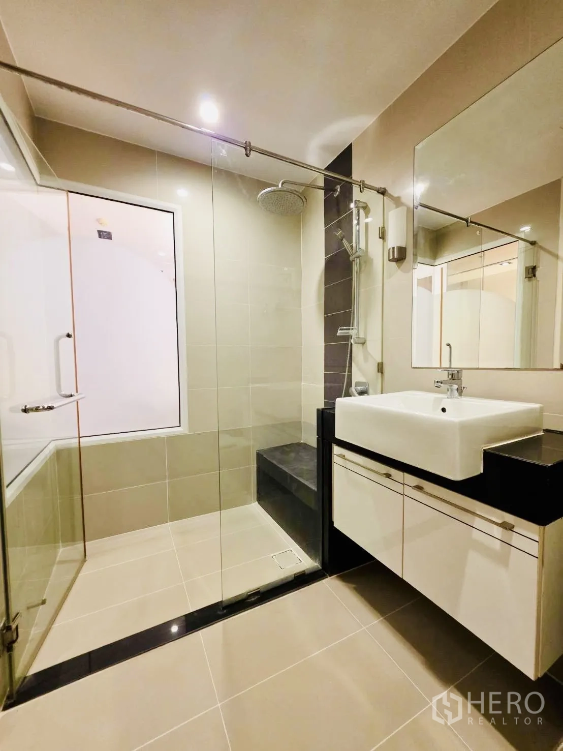คอนโด for rent in Huai Khwang, Bangkok - ห้องน้ำสมัยใหม่ กั้นอาบน้ำกระจก เรนชาวเวอร์ และอ่างล้างหน้าพร้อมตู้เก็บของ