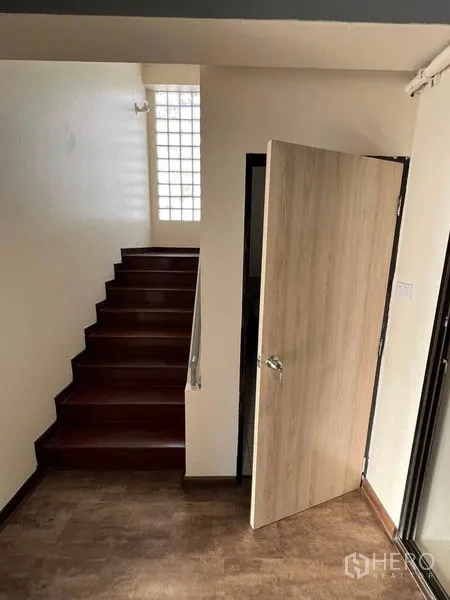 Office Space for rent or sale in Suan Luang, Bangkok - Internal staircase and light wood door leading to the upper office level.