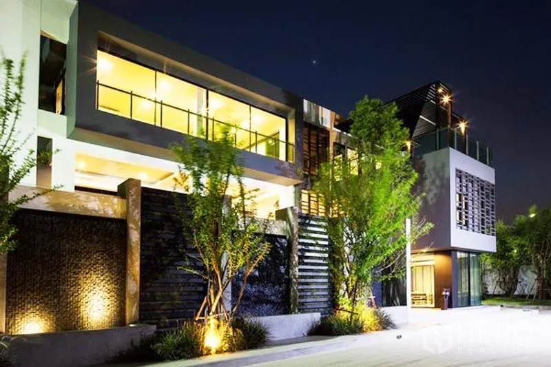 Detached House for rent or sale in Bang Kapi, Bangkok - Clubhouse exterior at night with large windows and accent lighting.