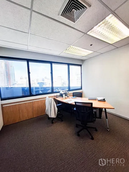 Office Space for rent in Bang Na, Bangkok - Corner executive office with a large window, two desks and a panoramic city outlook.