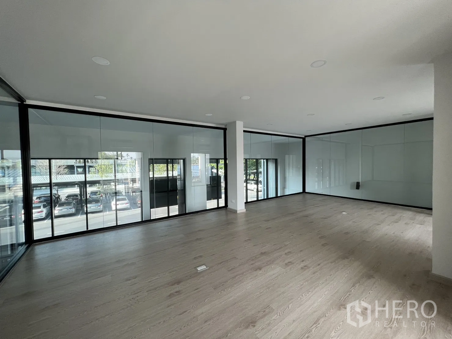 Home Office for rent in Bang Phli, Samut Prakan - Upper floor office with wood flooring and glass partitions overlooking the street.