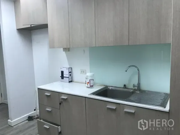 Retail Space for rent in Pathum Wan, Bangkok - Pantry with stainless sink, light wood cabinets and solid-surface countertop.