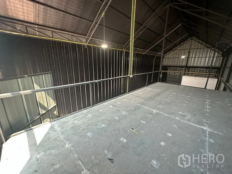 Warehouse for rent in Bueng Kum, Bangkok - Mezzanine storage platform with guardrail under an insulated roof, overlooking the warehouse floor.