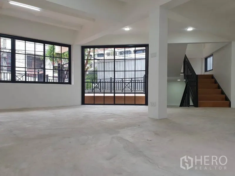 Home Office for rent or sale in Bang Na, Bangkok - Open-plan area with stairway and sliding doors to the terrace.