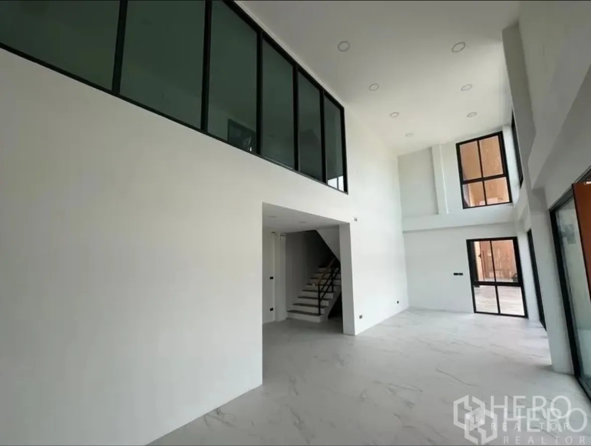 仓库 for sale in Lam Luk Ka, Pathum Thani - 明亮的双层办公区，带楼梯与大面积玻璃采光面。