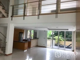Townhouse for rent or sale in Yan Nawa, Bangkok - Open-plan living and kitchen opening to patio via wide sliding doors.