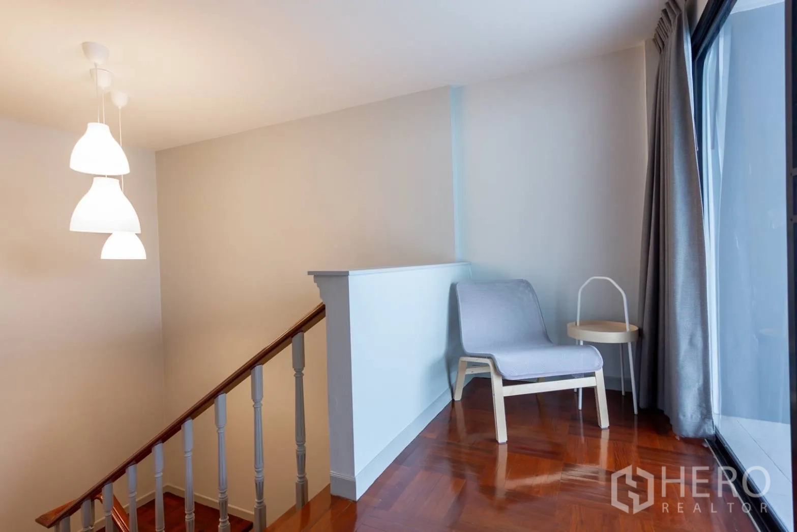 Home Office for rent in Bang Rak, Bangkok - Stair landing with pendant lights, lounge chair and balcony access.