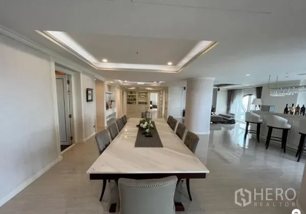 Condominium for sale in Bang Rak, Bangkok - Dining area view showing a long marble-top table in a luxury open-plan condo.