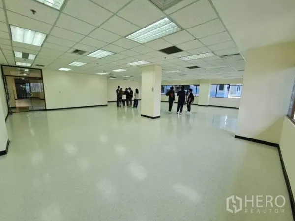 办公空间 出租在Watthana, Bangkok - 宽敞开放式办公室，格栅吊顶灯、光亮地面与大窗户采光充足。