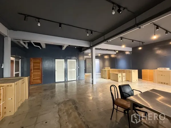 Office Space for rent in Wang Thonglang, Bangkok - Spacious workspace with dark accent walls, exposed beams and multiple AC units.