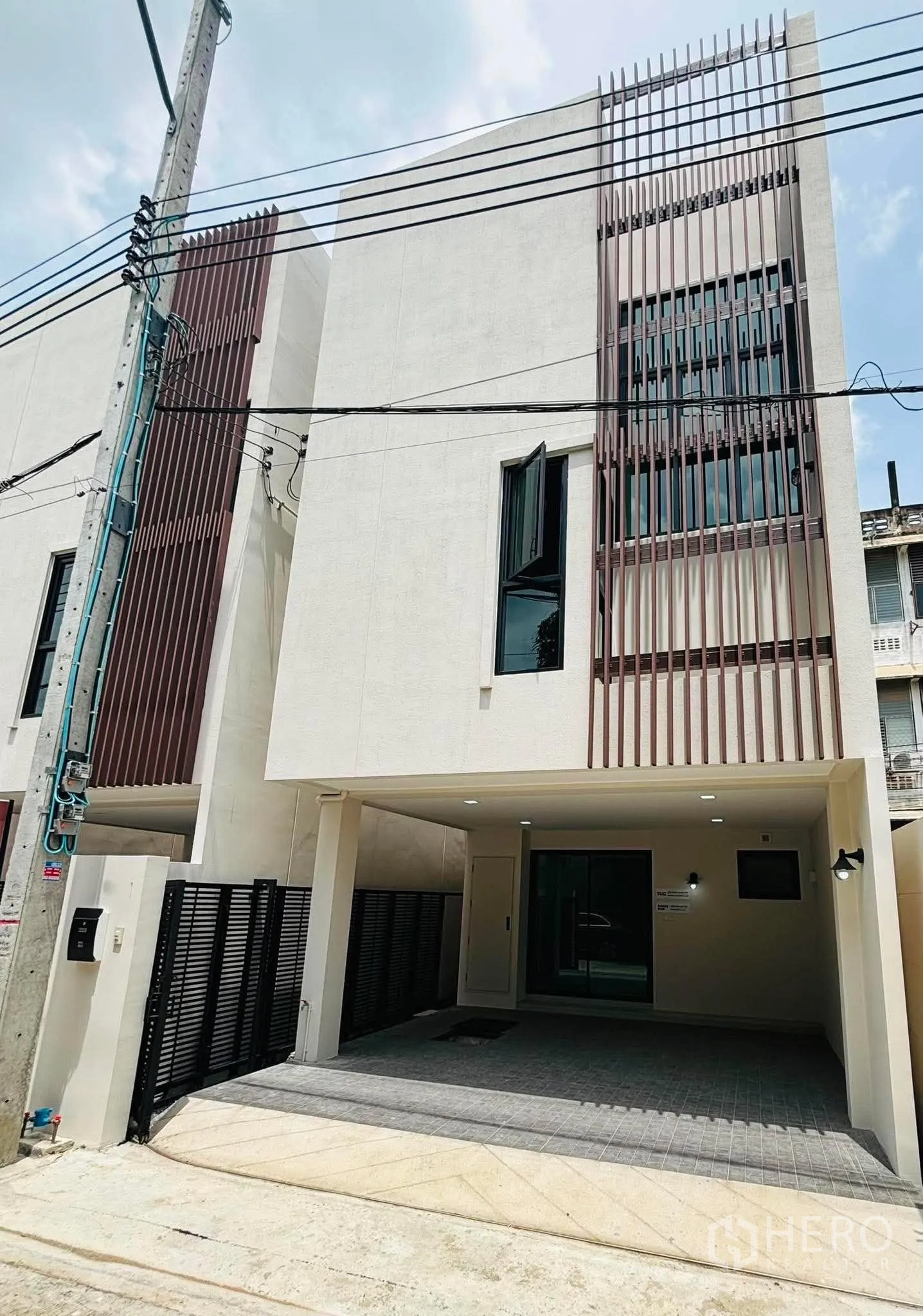 Home Office for rent in Phra Khanong, Bangkok - Modern multi-storey home office exterior with covered carport and vertical slats.