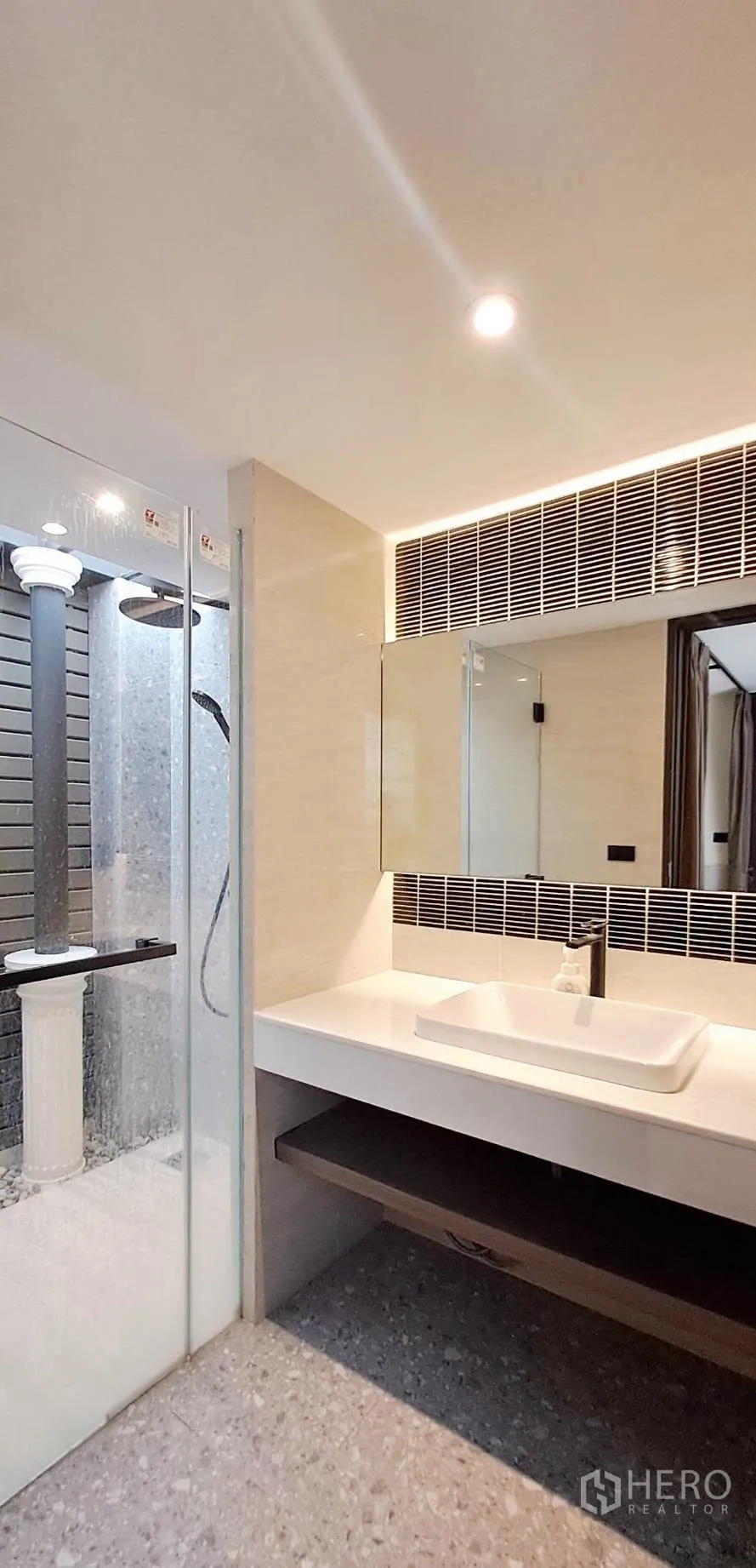 Home Office for rent in Lat Phrao, Bangkok - Modern bathroom with glass shower, wide vanity and backlit mirror.