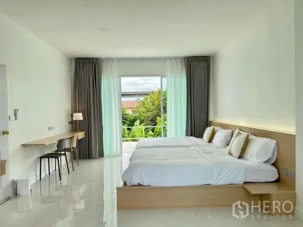 Detached House for rent in Lat Krabang, Bangkok - Bright bedroom with twin beds, floor‑to‑ceiling curtains and a balcony overlooking greenery.