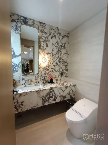 Detached House for sale - Chic powder room with dramatic marble feature wall and modern toilet.