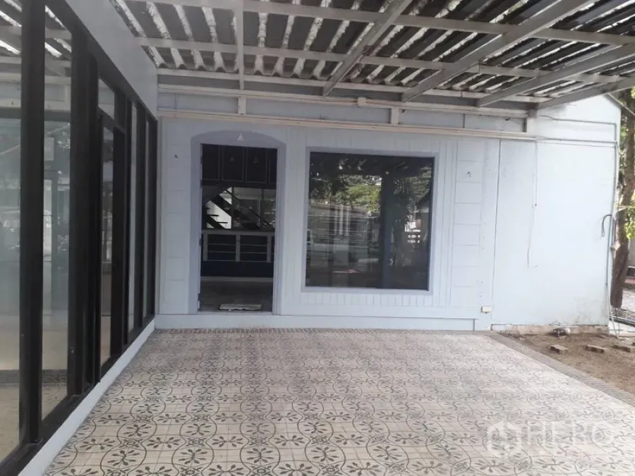 Detached House for rent in Watthana, Bangkok - Covered terrace with patterned tiles and a large window at a detached house in Watthana, Bangkok.