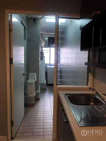 Condominium for sale in Yan Nawa, Bangkok - Utility area off the kitchen with sink, glass partition and laundry space.