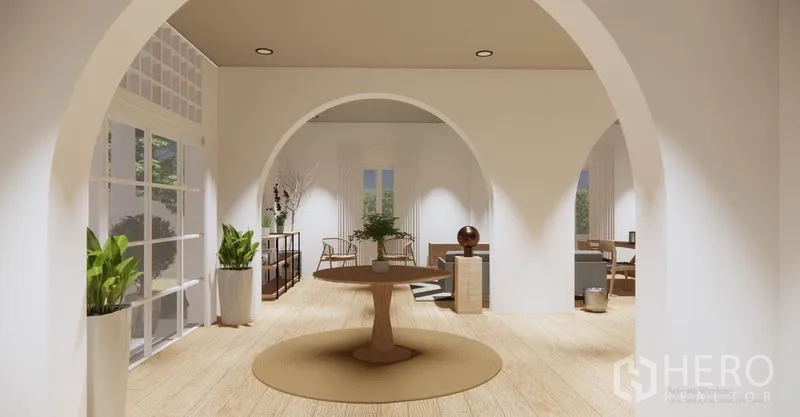 Detached House for rent in Khlong Toei, Bangkok - Central round-table foyer framed by white arches and indoor greenery connecting multiple rooms.