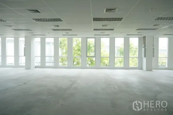 办公空间 出租在Bang Na, Bangkok - 采光充足的空置开放式办公室，整面落地窗与吊顶，配照明与空调出风口。