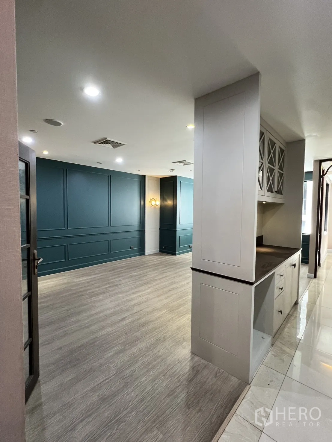 Office Space for rent in Watthana, Bangkok - Lounge or meeting area with teal paneled walls and built-in cabinet.