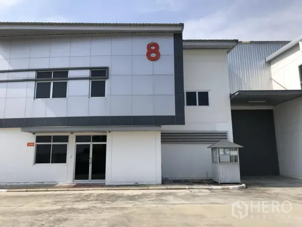 Factory for rent in Phra Nakhon Si Ayutthaya - Modern factory unit with number 8, glass-front office and a large roller shutter.