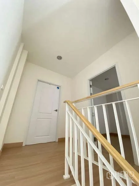 Home Office for rent or sale - Stair landing with white handrails connecting the upper levels.
