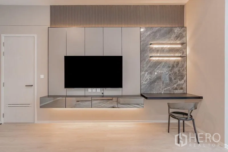 Detached House for rent - Close-up of TV feature wall with floating console and marble-clad desk.