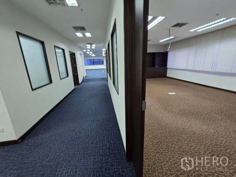 Office Space for rent in Khlong Toei, Bangkok - View from corridor into a large carpeted room within the office suite.