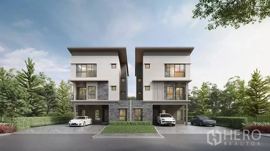 Detached House for rent in Saphan Sung, Bangkok - Modern three-storey houses with carports and landscaped driveways in a quiet Bangkok community.
