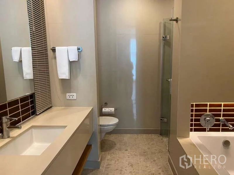 Condominium for rent in Bang Kho Laem, Bangkok - Large bathroom with separate tub, vanity, and shower enclosure.