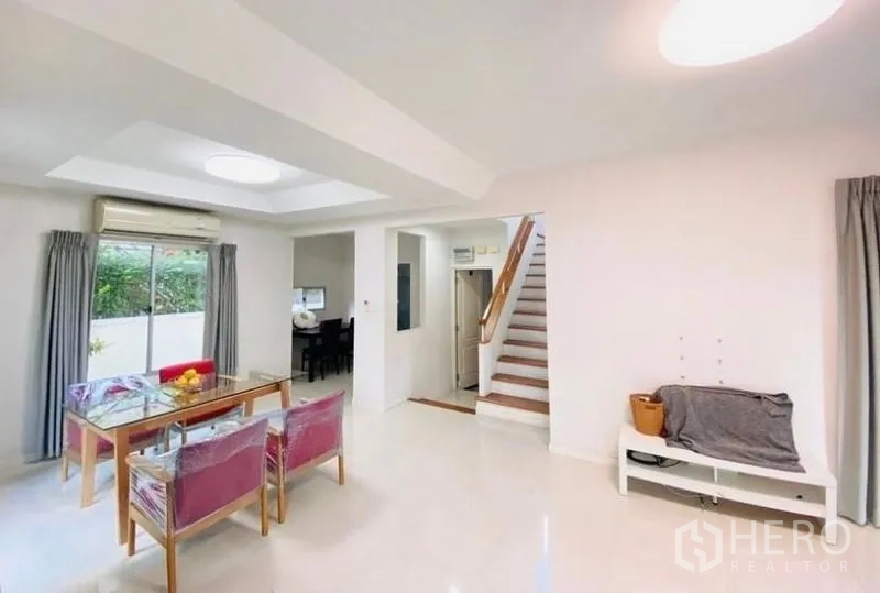 Detached House for rent or sale - Open‑plan living and dining space with recessed ceiling, white walls and a staircase leading upstairs.