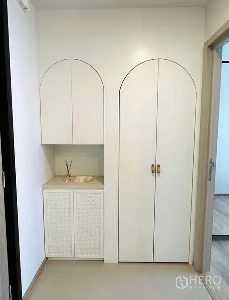 Condominium for rent - Built-in arched storage cabinets in the hallway of a modern condo.