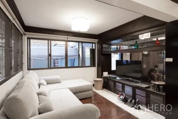 Detached House for rent in Watthana, Bangkok - Living room with L-shaped sofa, built-in media cabinet and wide windows.