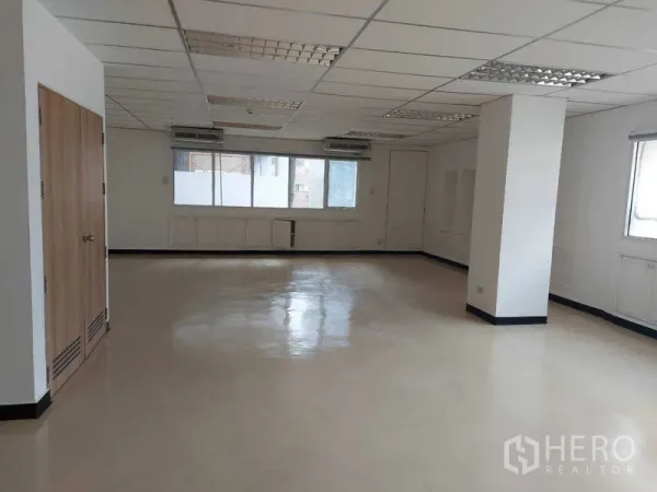 Office Space for rent in Pathum Wan, Bangkok - Spacious open-plan office with grid ceiling lights, wall-mounted air conditioners, and large windows.