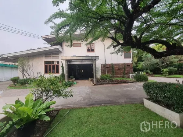 带办公室的家 出租在Watthana, Bangkok - 两层住办两用主楼外观，草坪与车道环绕