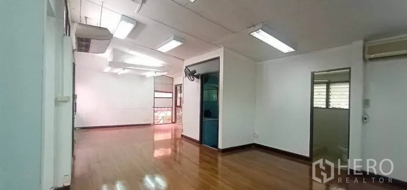 Home Office for rent in Watthana, Bangkok - Bright tiled multipurpose room with sliding glass partitions and windows