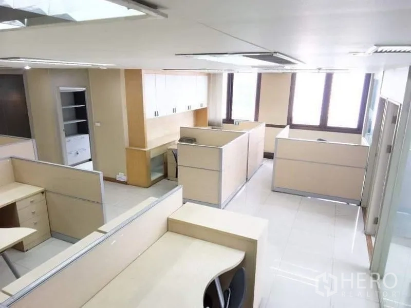 Office Space for rent - Open-plan workspace featuring multiple cubicles, overhead lighting and natural light from windows.
